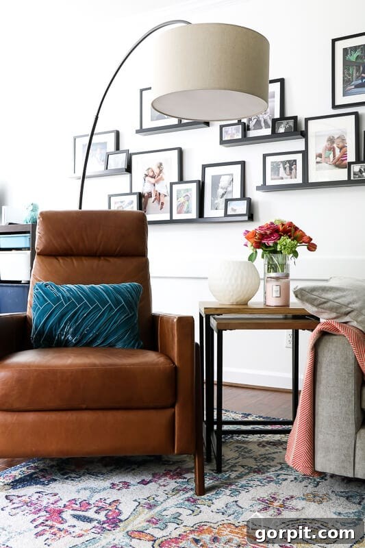 The sleek West Elm Spencer recliner positioned comfortably in the colorful family room, demonstrating its modern design and inviting presence.