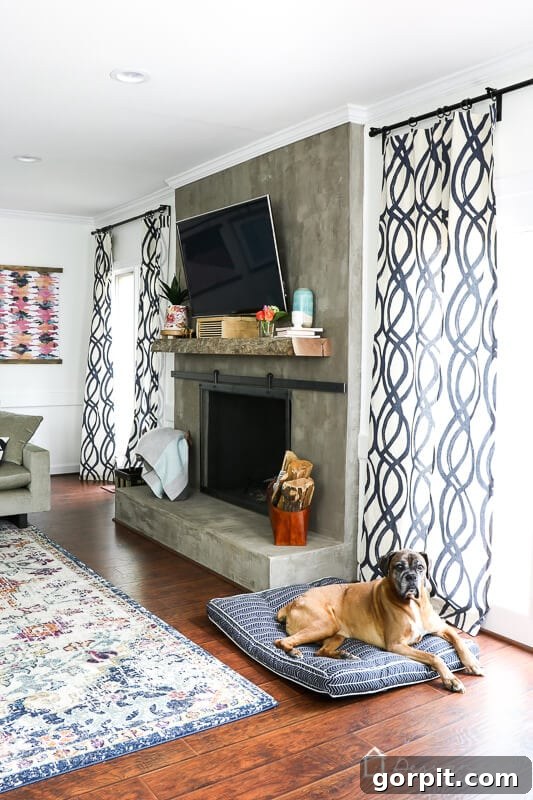 A cozy corner of the West Elm colorful family room, featuring ambient lighting, a section of the sofa, and a glimpse of the fireplace.