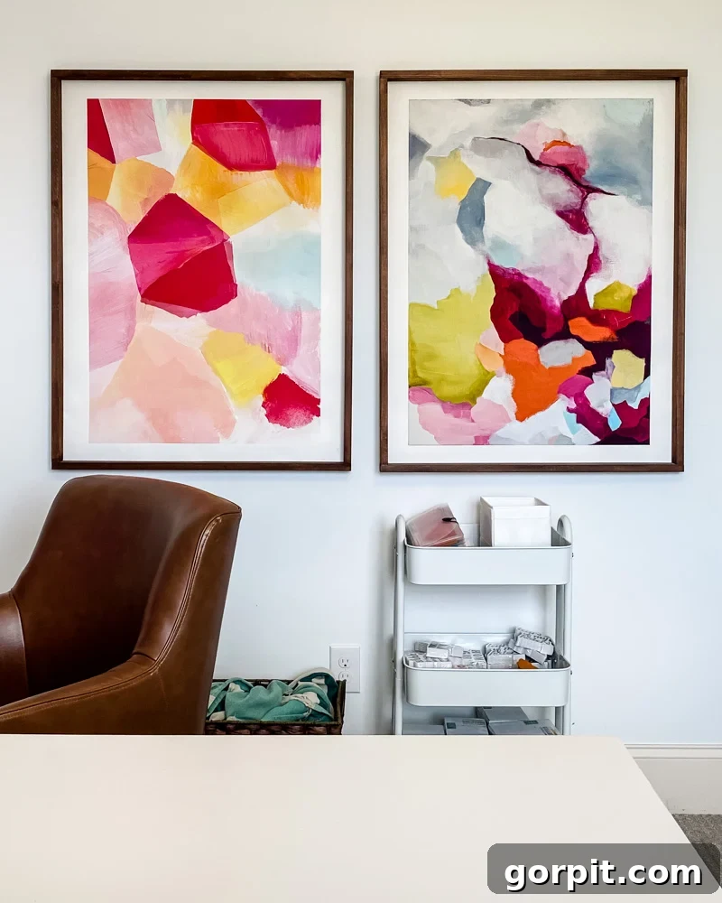 Large abstract colorful art in a home office, framed in wood