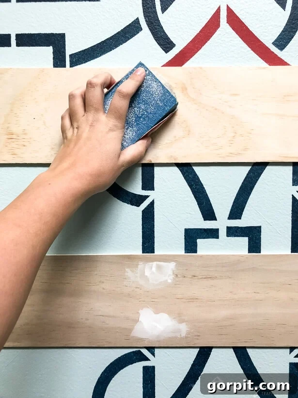 Sanding patched nail holes for a smooth finish on plank wall