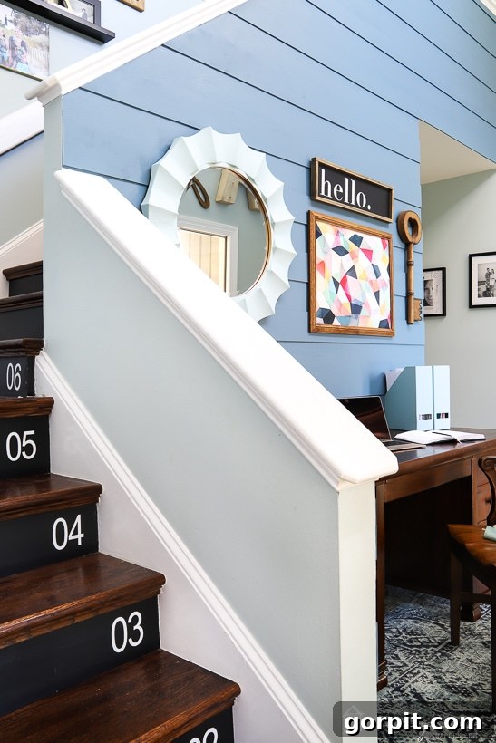Modern Foyer with Plank Wall and Decorative Mirror
