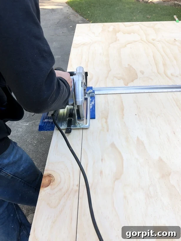 Ripping plywood into 5-inch planks with a circular saw and guide