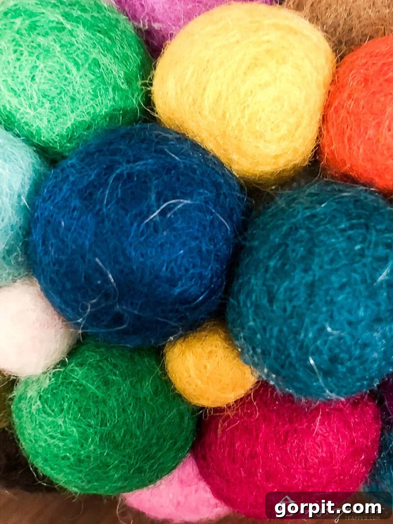Close-up detail of the felt ball wreath, highlighting how smaller felt balls are used to fill in tiny gaps for a complete look