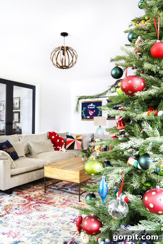 A Kaleidoscope Christmas 8 A cozy living room adorned with a vibrant, colorful Christmas tree, showcasing the harmonious blend of holiday decor with everyday comfort.