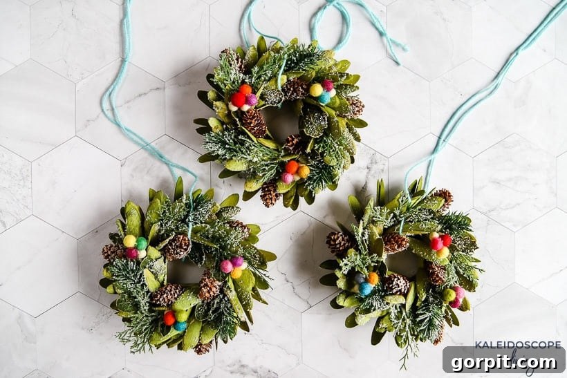Mini wreaths can be such a cute and festive touch when decorating for Christmas. We added mini wreaths to our kitchen cabinets this year, and they are my new favorite thing! In this post, I share how we customized and hung our mini wreaths, plus I've rounded up the cutest mini wreaths out there that you can buy! #christmasdecor #miniwreaths #christmaswreaths #christmasdecorations #wreath #wreaths