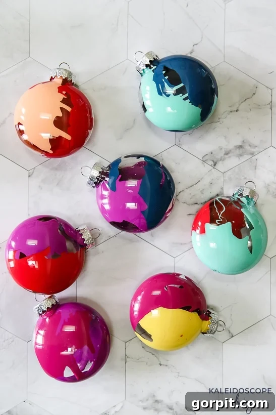 Vibrant and Effortless Christmas Crafting 2 Vibrant, handcrafted DIY Christmas ornaments showcasing a stunning colorful marbling effect, perfect for holiday decor.