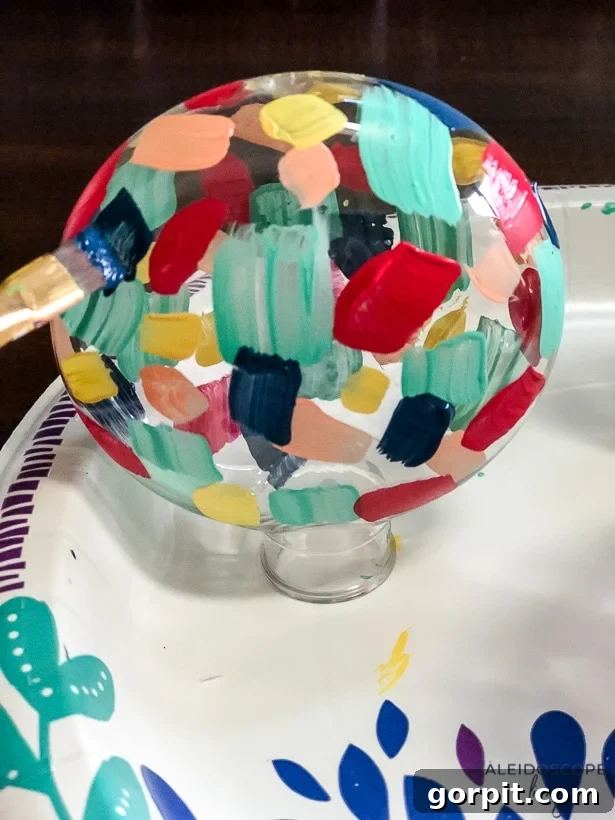 Crafting Unique Painted Holiday Treasures 6 The process of painting a plastic ornament with multiple brushstroke layers