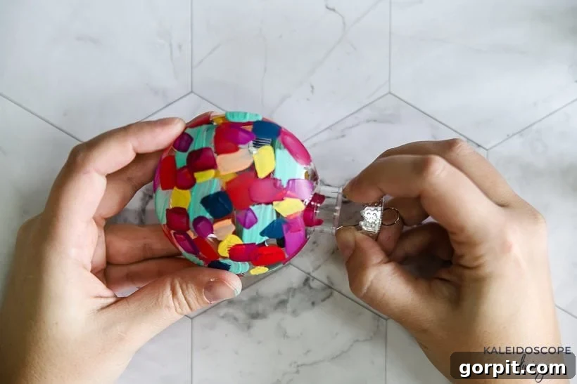 Crafting Unique Painted Holiday Treasures 7 Assembling a finished hand painted plastic Christmas ornament