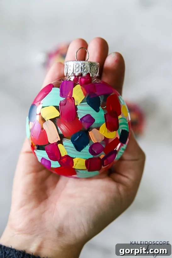 Crafting Unique Painted Holiday Treasures 8 Close-up of a colorful hand painted plastic Christmas ornament held in hand