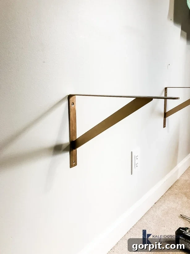 hanging wall brackets for DIY floating desk by Tasha Agruso of Kaleidoscope Living, close-up of a securely installed bracket on a wall