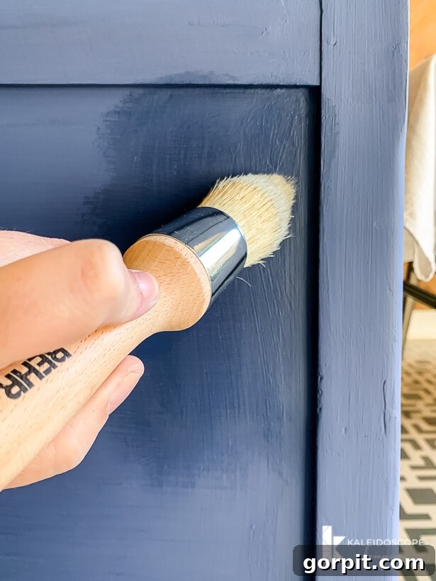 Chalk Paint Furniture Makeovers Step by Step 8 Waxing furniture with Behr Decorative Wax Finish, showing the application of a protective topcoat for enhanced durability and sheen.