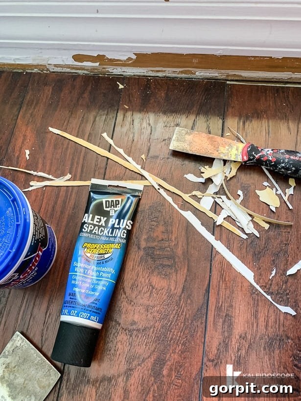 Easy Ways to Repair Chipped Baseboards 4 Damaged baseboard showing chipped paint and old caulk before repair, emphasizing the areas needing attention
