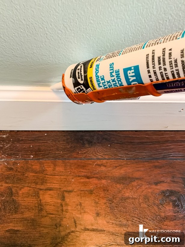 Easy Ways to Repair Chipped Baseboards 8 Applying DAP Alex Plus caulk along the seam where baseboard meets the wall, ensuring a smooth finish