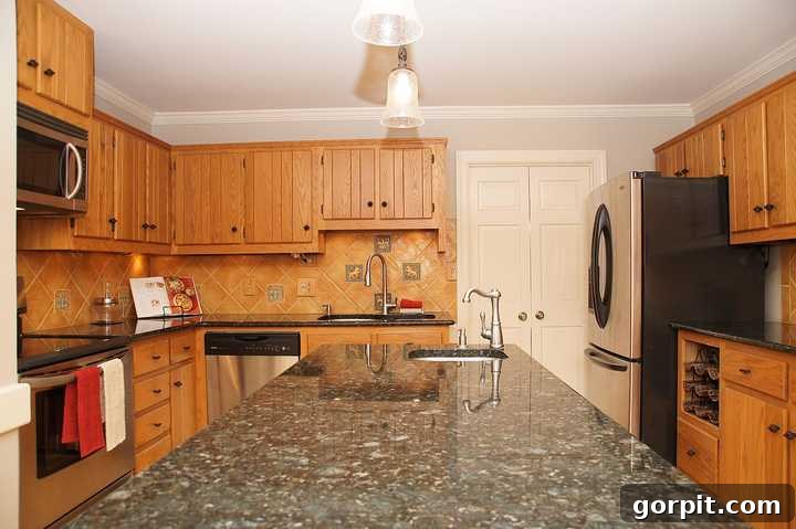 Vibrant Kitchen Transformation Unveiled 3 orange oak cabinets in outdated kitchen, showing a cramped and dark space