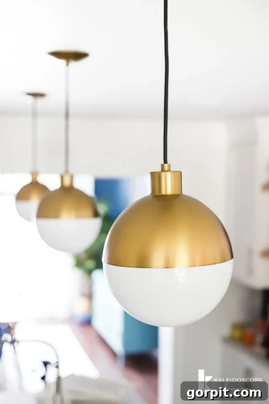 Vibrant Kitchen Transformation Unveiled 24 modern gold and white pendant lights in kitchen remodel, creating a stunning focal point