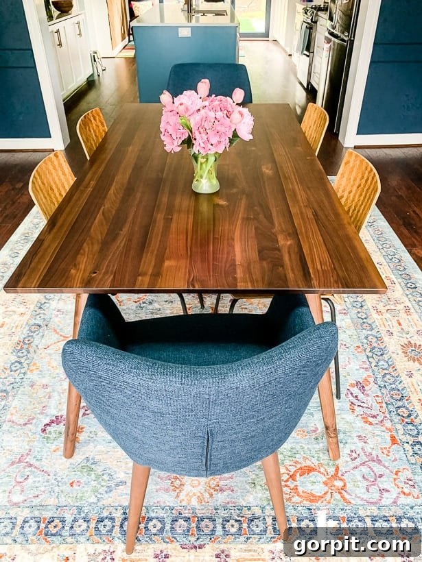 Seno walnut extendable dining table by Article, the centerpiece of a modern navy blue dining room