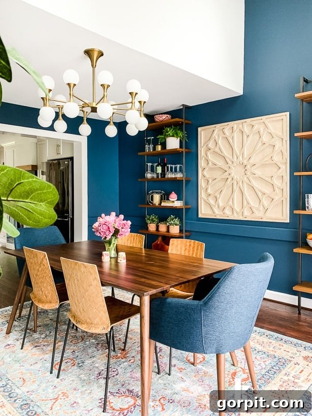 Dining room showcasing Article's Seno walnut table and Feast twilight blue chairs in a navy blue setting