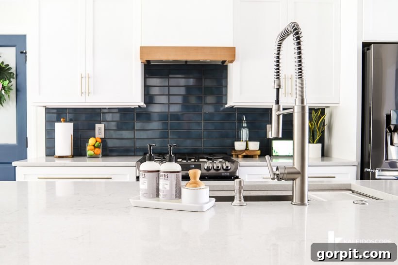 DIY Wood and White Concrete Range Hood 2 kitchen with white cabinets and navy blue tile backsplash and custom DIY range hood