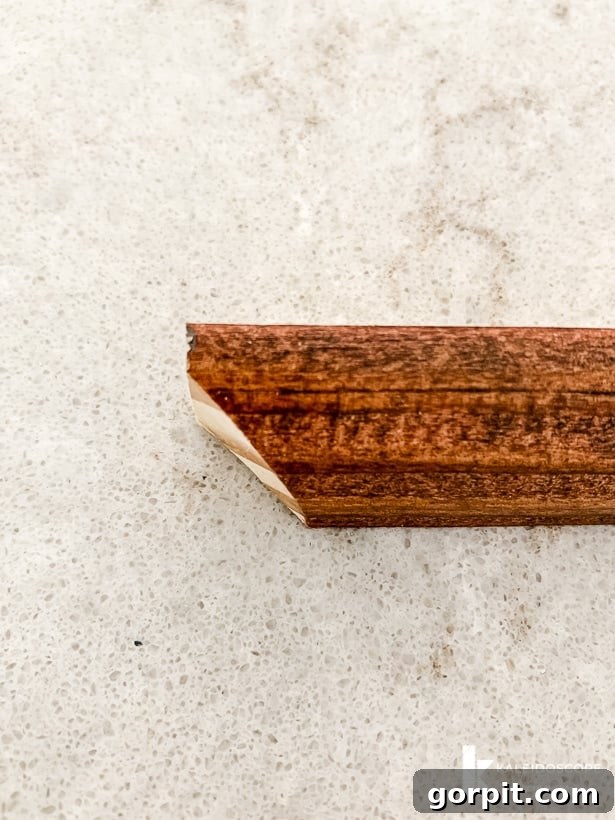 Your Guide to Perfect Quarter-Round Molding 7 A finished edge of quarter round molding after staining and coping, showing the unique