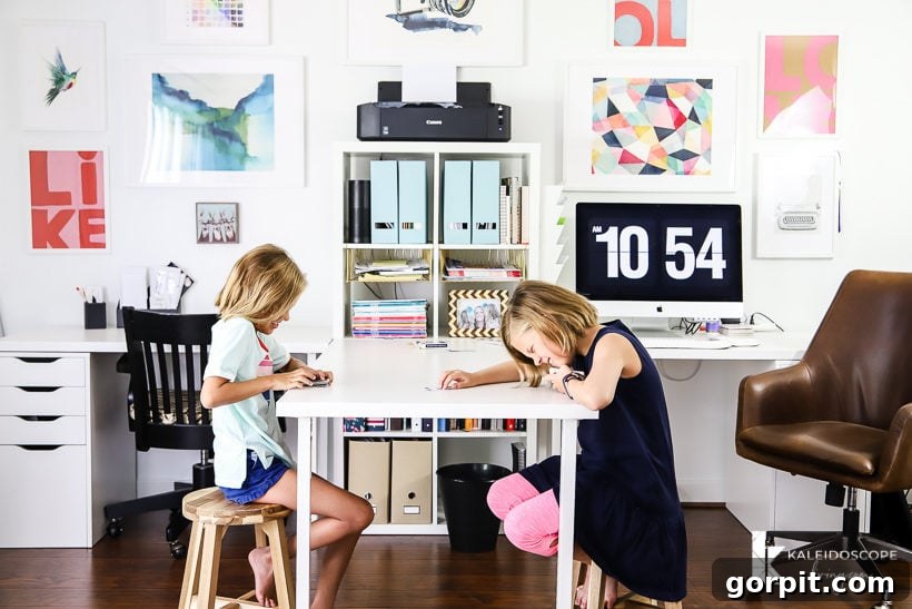 Home office with a double desk setup, designed for two people with practical organization and stylish decor.