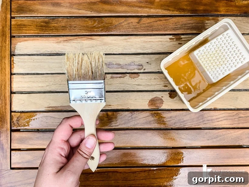 Bring Your Teak Back to Life: 4 Simple Steps 12 Applying teak oil to outdoor dining table