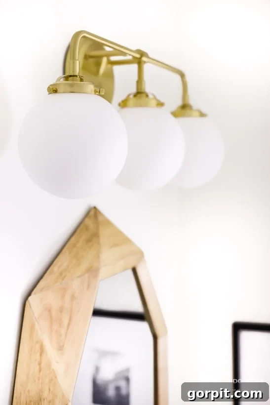Satin brass vanity light fixture from Build.com in a renovated bathroom.