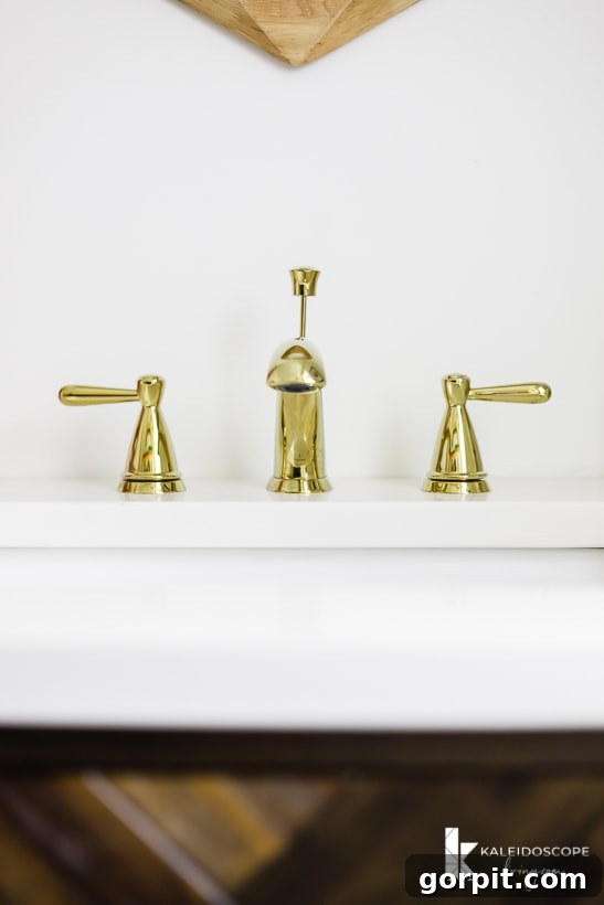 Close-up of the Delta Peerless Faucet in polished brass, reflecting the colorful wall mural.