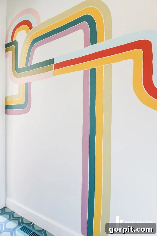Colorful hand-painted wall mural in a powder room, showcasing a unique geometric design.