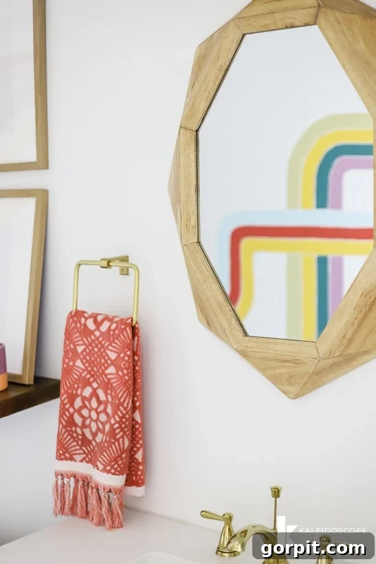 View of a colorful modern DIY bathroom remodel, with a close-up of the vanity and mural.