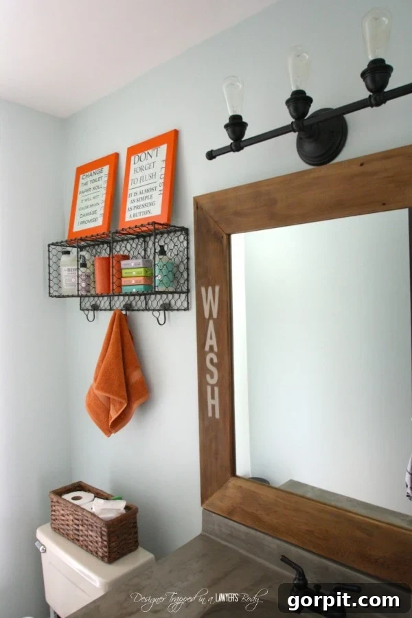 Powder room after a light refresh with painted cabinets and a DIY concrete overlay mirror frame.