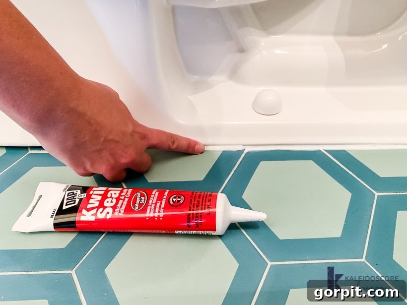 Finished caulking around the toilet base, drying to a clear, sealed finish