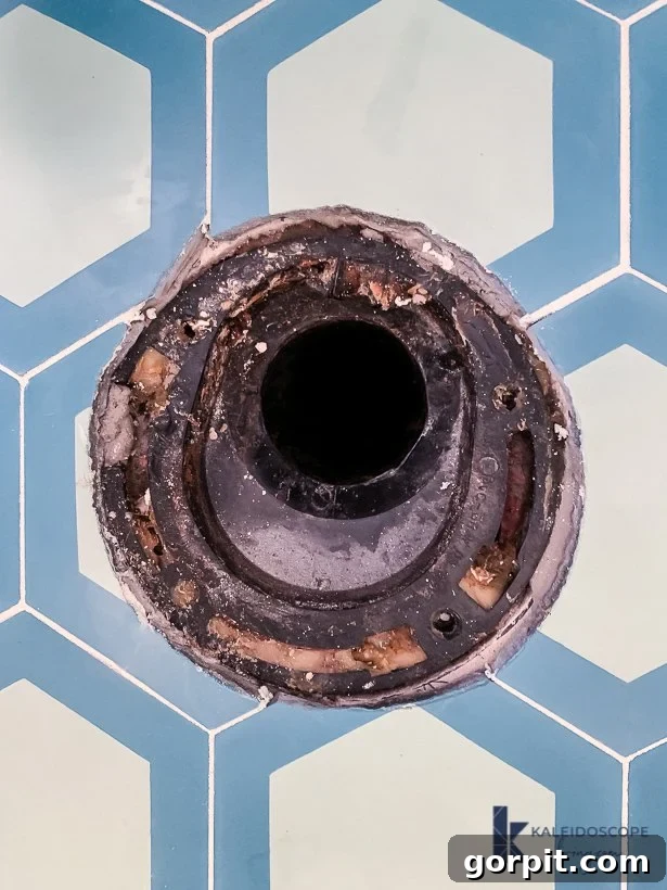 Cracked toilet flange requiring repair before new toilet installation