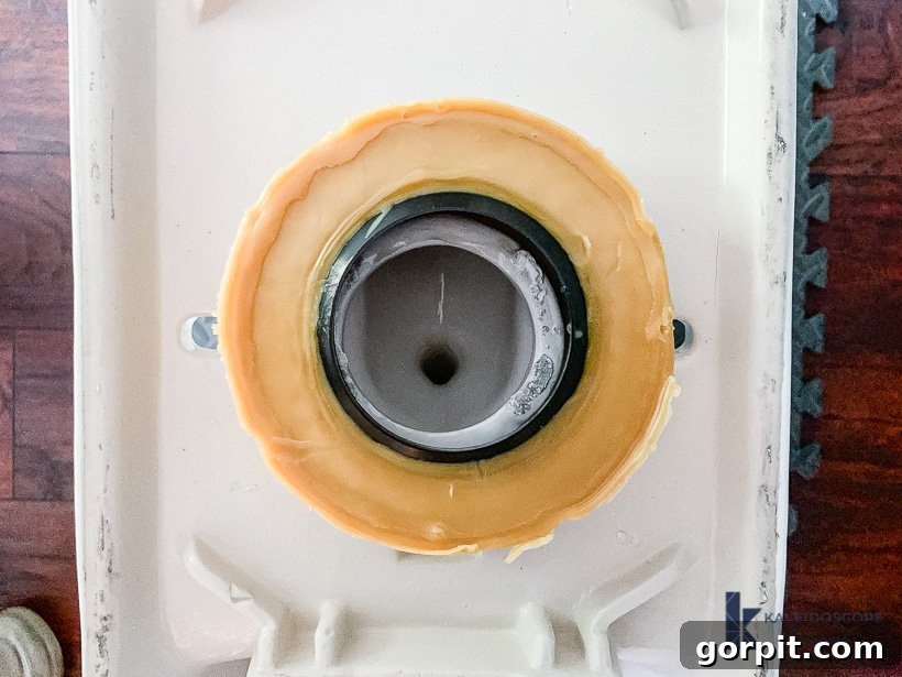 Attaching a new wax ring to the bottom of the toilet bowl for a perfect seal