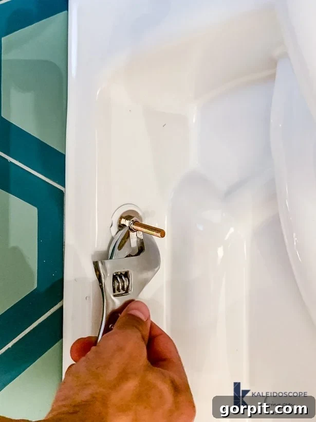 Yeni Başlayanlar İçin Adım Adım Tuvalet Montaj Rehberi 7 Tightening the bolts on the toilet bowl base for a secure installation