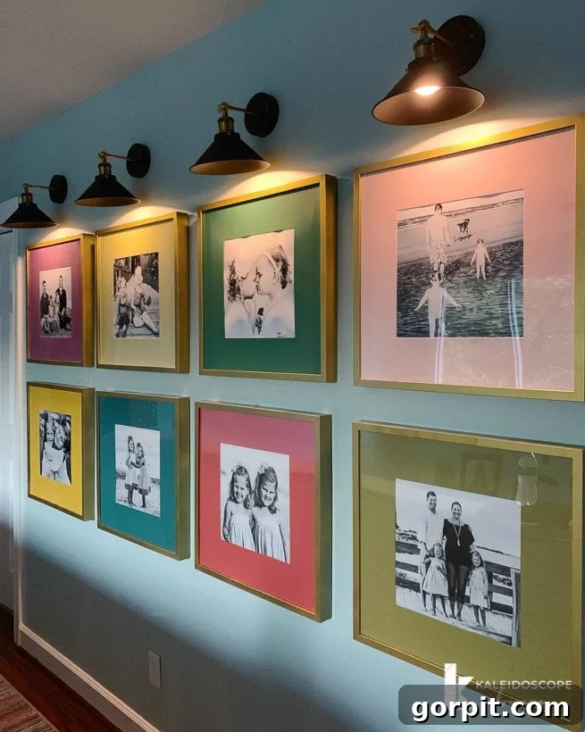 Vibrant photo gallery wall illuminated by sconces, adding warmth and sophistication