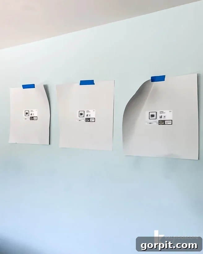 Planning a photo gallery wall layout using paper templates and painter's tape