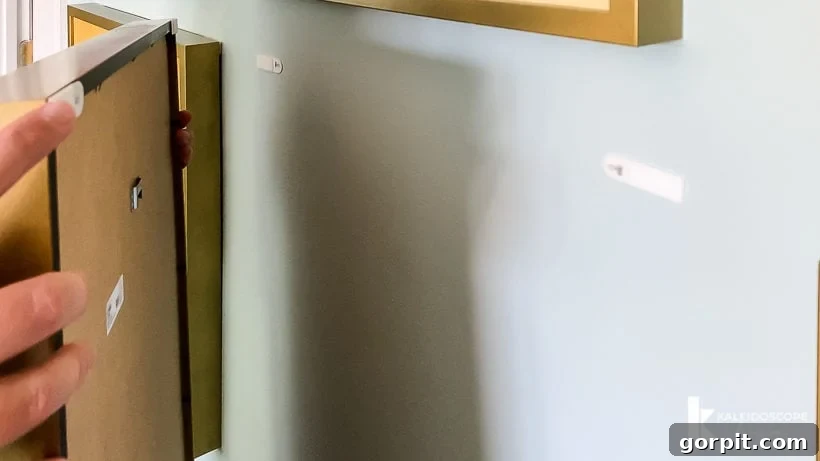 Hanging photos with Command Picture Hanging Strips for a secure and level display