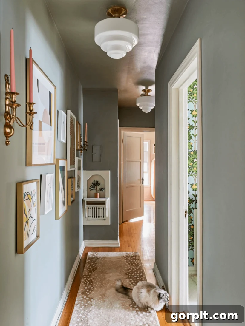 long hallway with gallery wall and matching light fixtures