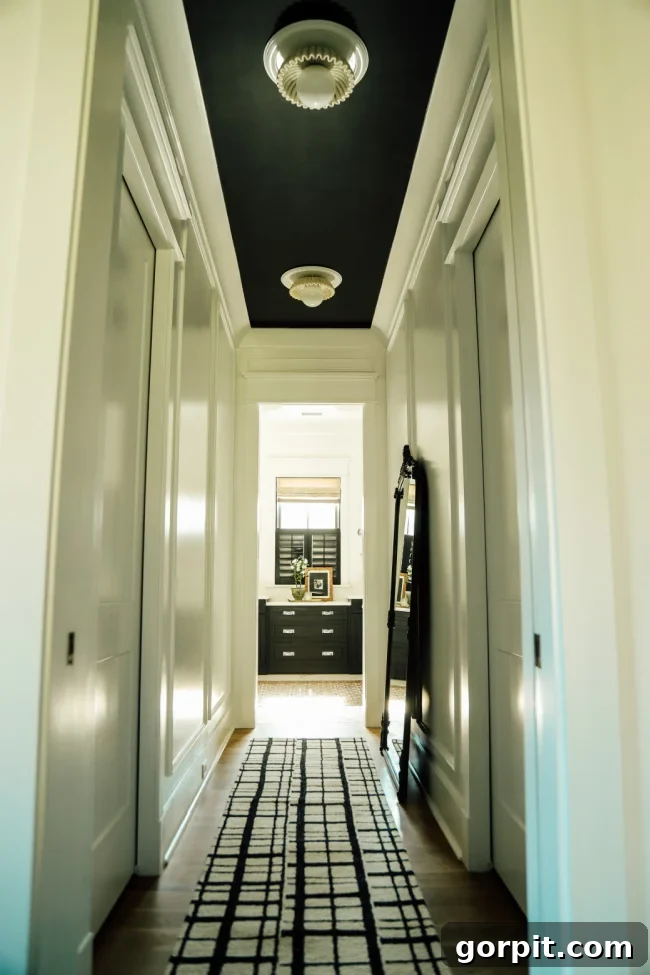 hallway with box molding and black ceiling
