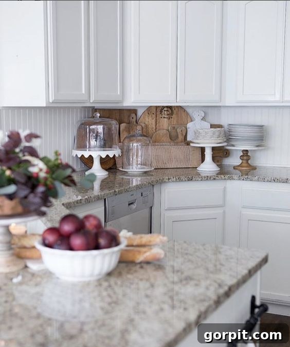 A DIY white beadboard backsplash makes a white kitchen look spacious and bright. 