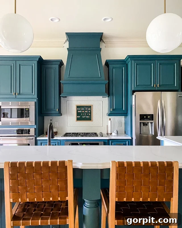 Deep turquoise cupboards and a light, painted backsplash gives this kitchen a DIY modern update. 