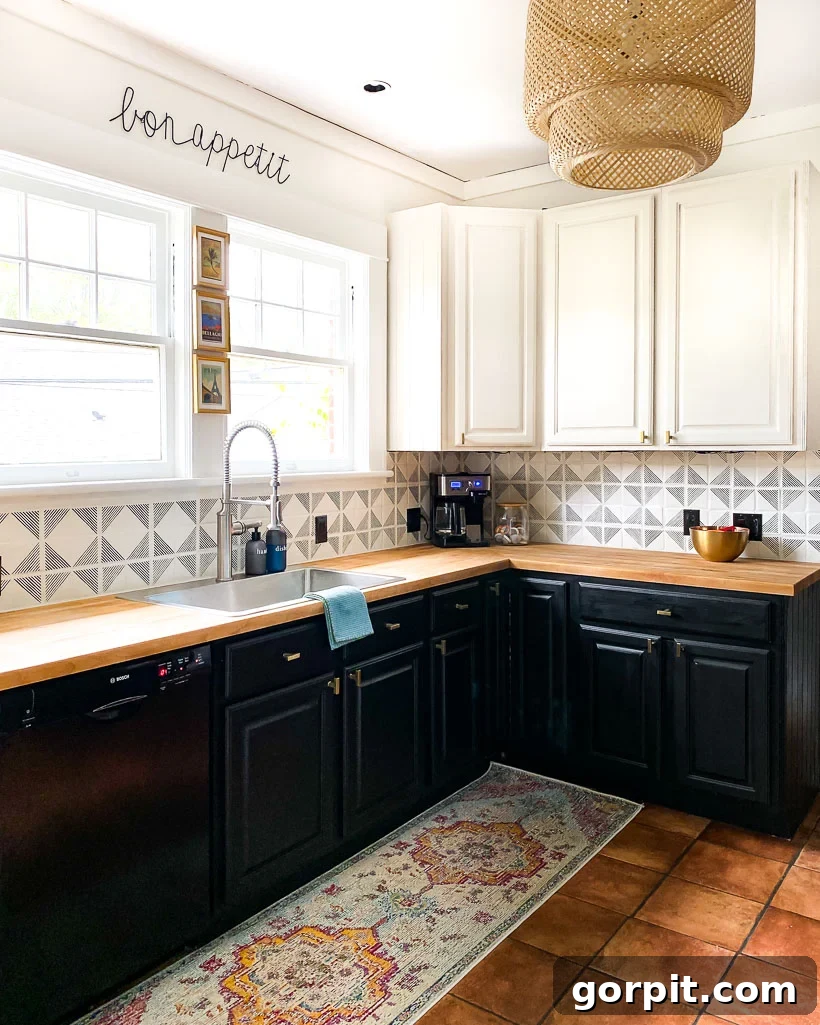 A bright, well-lit kitchen features a hand-painted backsplash that looks like tile and complements the dark cupboards. 