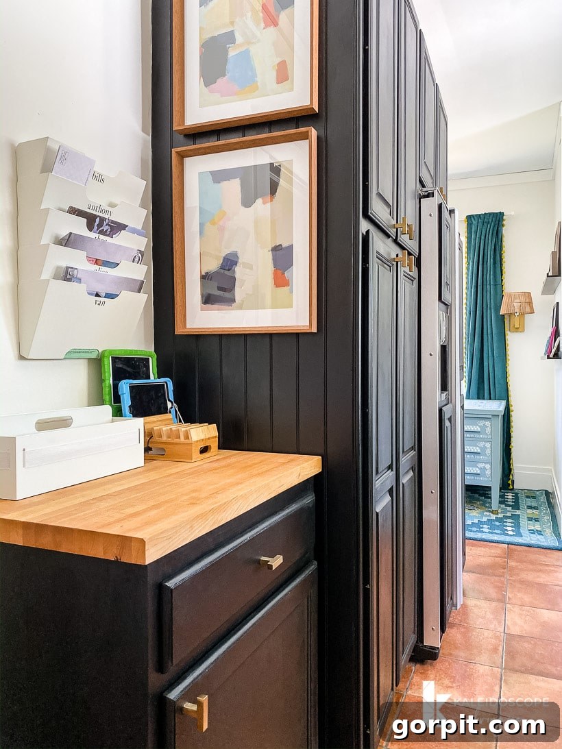 Small Budget Big Impact DIY Kitchen Transformation 18 A family "command center" on a small cabinet with a wood top on the other side of a large pantry wardrobe, all added in a budget-friendly kitchen makeover.