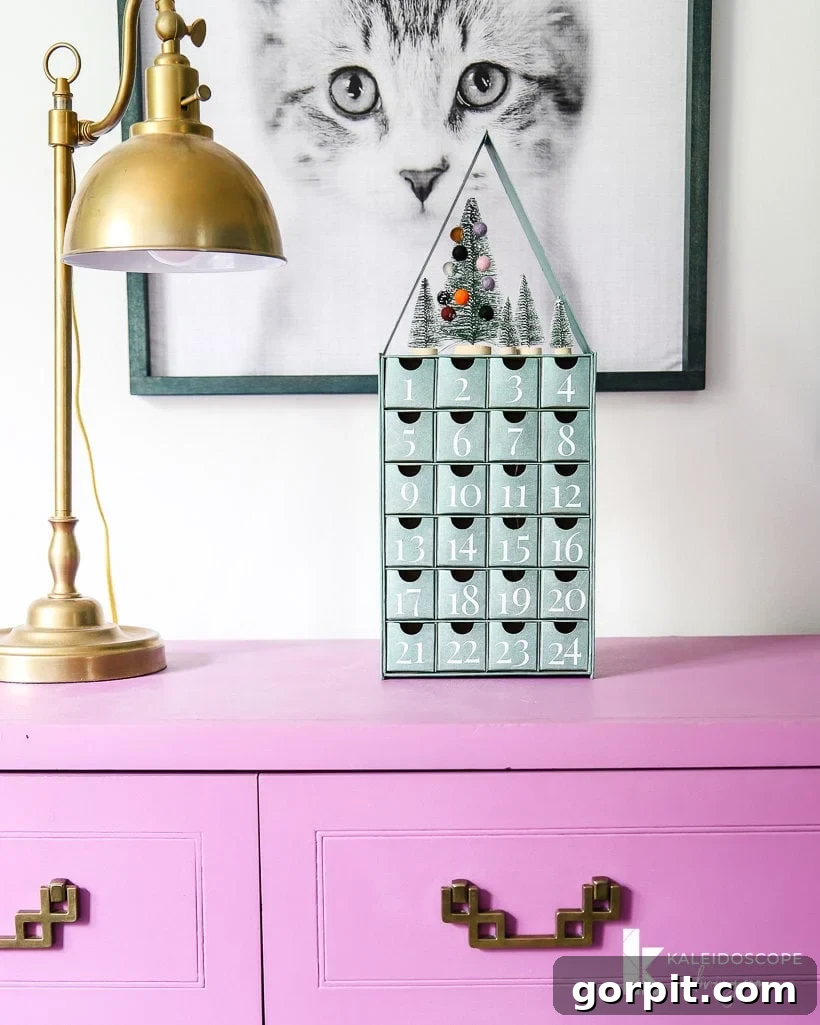 Close-up of the glitter-numbered drawers on the metallic blue-green Advent calendar, highlighting the elegant personalization.