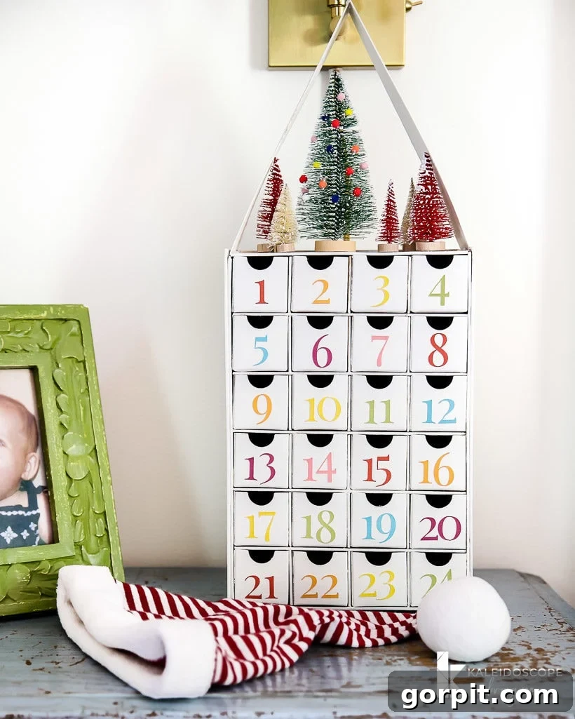 Completed colorful DIY Advent calendar with a vibrant rooftop and miniature bottlebrush trees, showcasing its personalized charm.