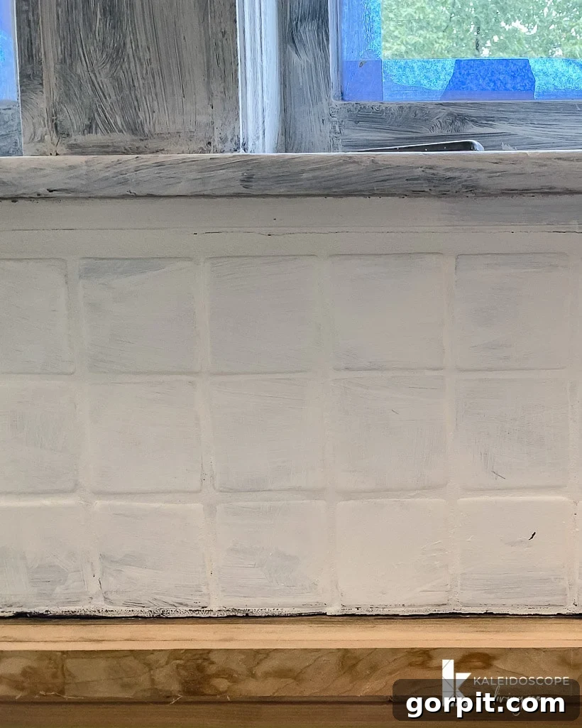 Transform Your Backsplash: 5 Easy Painting Steps 8 backsplash after one coat of paint
