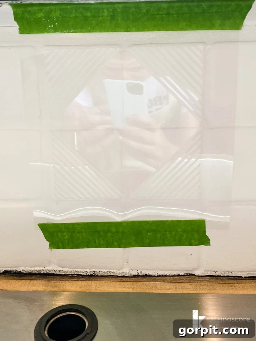 Transform Your Backsplash: 5 Easy Painting Steps 9 applying stencil to painted backsplash