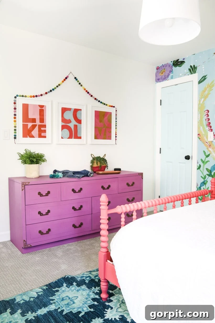Colorful girl's bedroom with a charming purple dresser, adding a vibrant accent to the space.