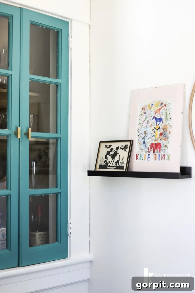 Colorful built-in cabinet and organized artwork in home office