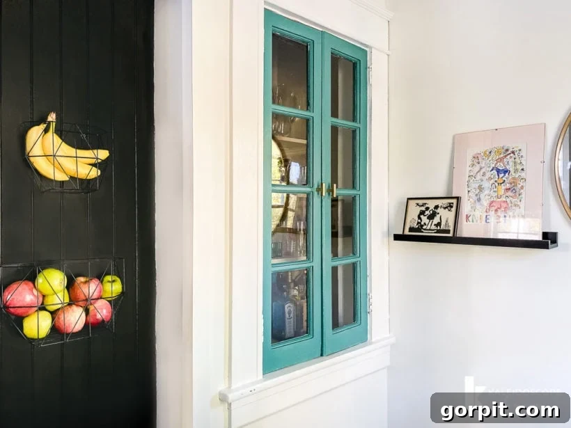 Colorful cabinet and artwork integrated with kitchen space